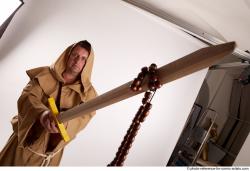 JOEL_ADAMSON STANDING POSE WITH SWORD AND CRUCIFIX